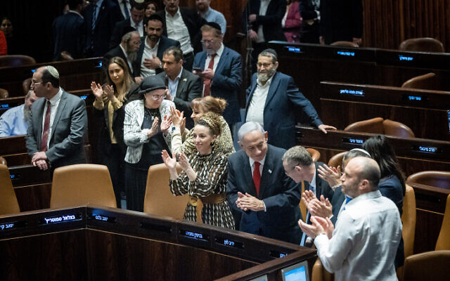 Prime Minister Benjamin Netanyahu (center) and Justice Minister Yariv Levin celebrate in the Knesset plenum on February 21, 2023. (Yonatan Sindel/Flash90) Prime Minister Benjamin Netanyahu (center) and Justice Minister Yariv Levin celebrate in the Knesset plenum on February 21, 2023. (Yonatan Sindel/Flash90)