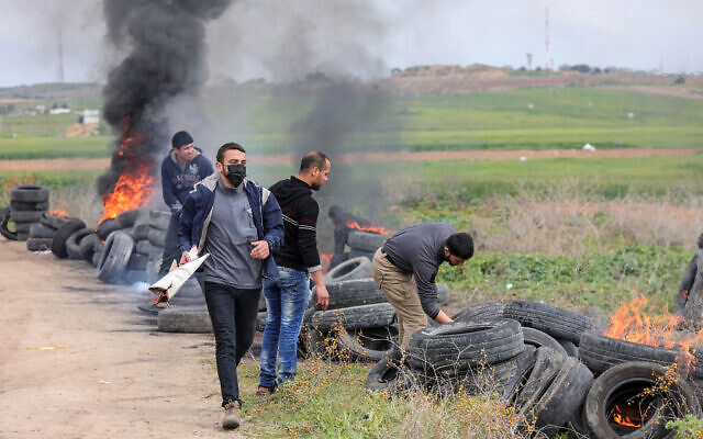 Palestinians burn tires during a protest on the border with Israel, east of Gaza City, February 23, 2023. (Atia Mohammed/Flash90) Palestinians burn tires during a protest on the border with Israel, east of Gaza City, February 23, 2023. (Atia Mohammed/Flash90)