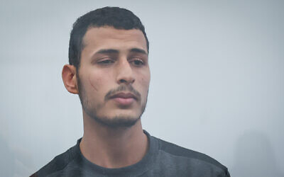 Barakhat Abu Essa, 22, from Tel Sheva, was indicted on February 23, 2023 for raping a woman in front of her children in their Gedera home in the early hours of February 2, 2023. He appears in this photo at a court hearing in Lod. (Flash90)