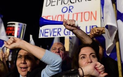 Israelis march in Tel Aviv during a protest against the Israeli government's planned judicial overhaul, February 25, 2023. (Tomer Neuberg/Flash90)