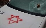 A car belonging to a Palestinian man graffitied with a Star of David during an alleged price tag attack east of the West Bank city of Hebron, February 14, 2023. (Social media screenshot: used in accordance with Clause 27a of the Copyright Law)