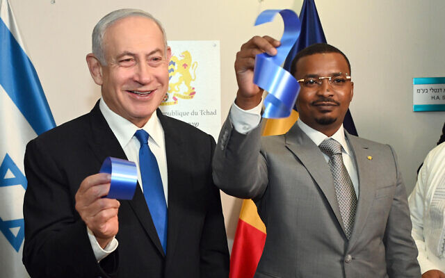 Prime Minister Benjamin Netanyahu (L) and Chad's President Mahamat Idriss Deby Itno hold up pieces of ribbon after a ceremony opening the embassy of Chad in Israel on February 2, 2023 (Haim Zach / GPO) Prime Minister Benjamin Netanyahu (L) and Chad's President Mahamat Idriss Deby Itno hold up pieces of ribbon after a ceremony opening the embassy of Chad in Israel on February 2, 2023 (Haim Zach / GPO)