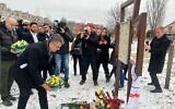 Foreign Minister Eli Cohen lays a wreath at a mass grave of 116 civilians slain by Russians in Bucha, in Kyiv, Ukraine, February 16, 2023. (Lazar Berman/Times of Israel)
