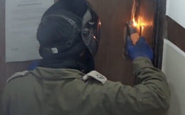 An IDF soldier welds a door shut, in the East Jerusalem neighborhood of A-Tur, February 12, 2023. (Israel Defense Forces) An IDF soldier welds a door shut, in the East Jerusalem neighborhood of A-Tur, February 12, 2023. (Israel Defense Forces)