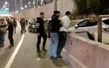 A driver suspected of dangerously veering toward anti-government protesters is arrested by police in Tel Aviv, February 25, 2023. (Screenshot/Twitter; used in accordance with Clause 27a of the Copyright Law)