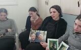 Devorah Paley holds a picture of her sons Yaakov Yisrael and Asher Menahem, who were killed in a February 10, 2023, terror attack in Jerusalem, as she speaks to reporters while marking the traditional Jewish mourning period, February 12, 2023. (Twitter screenshot; Used in accordance with Clause 27a of the Copyright Law)