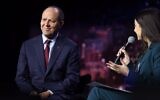 Israel's Economy Minister Nir Barkat speaks with Cybertech’s Shir Meir at the Cybertech Global conference in Tel Aviv on February 1, 2023. (Gilad Kavalerchik)