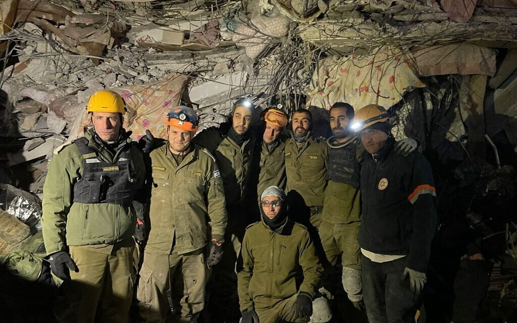 Lt. Col. Golan Landsberg, left, stands with other members of his search-and-rescue unit outside a collapsed building in Marash, Turkey, on February 8, 2023. (Israel Defense Forces) Lt. Col. Golan Landsberg, left, stands with other members of his search-and-rescue unit outside a collapsed building in Marash, Turkey, on February 8, 2023. (Israel Defense Forces)