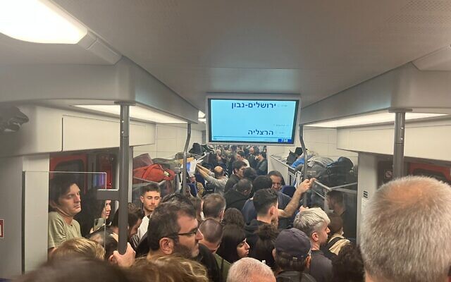 Demonstrators cram onto a train on their way back home from a mass protest in Jerusalem against the government's judicial overhaul plans, February 13, 2023. (Naomi Lanzkron/Times of Israel) Demonstrators cram onto a train on their way back home from a mass protest in Jerusalem against the government's judicial overhaul plans, February 13, 2023. (Naomi Lanzkron/Times of Israel)