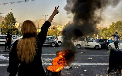 Iranians protest the death of 22-year-old Mahsa Amini after she was detained by the morality police, in Tehran, October 1, 2022. (AP Photo/Middle East Images, File)