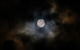 The full moon apears from behind the clouds in Tulum, Mexico, February 4, 2023. (David Gannon/AFP)