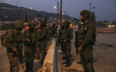 IDF soldiers patrol the main road in Huwara in the West Bank, on February 27, 2023. (Ronaldo Schemidt/AFP)