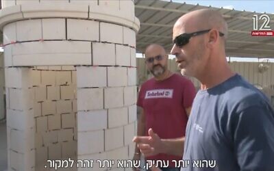 IAA Jerusalem renovation expert Yossi Vaknin stands alongside a replacement top section for the renovated Tower of David (Channel 12 news screenshot; used in accordance with Clause 27a of the Copyright Law)