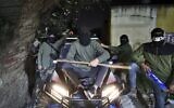 Masked Palestinian men pose for a picture as they take part in a night patrol in the village of Turmus Ayya in the West Bank, late on February 28, 2023. (Zain Jaafar/AFP)