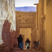 Women chat in the Jewish neighborhood, or 'mellah,' in the village of Tagadirt in Morocco's oasis region of Tata on February 28, 2023. (Fadel Senna/AFP)