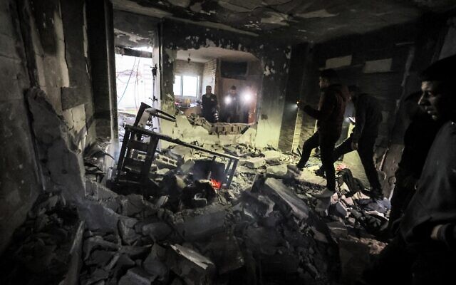People inspect the wreckage of a building that was housing a group of Palestinian gunmen and was hit by rockets during an Israeli army raid in the Jenin camp for Palestinian refugees in the West Bank on March 7, 2023. (Jaafar Ashtiyeh/AFP) People inspect the wreckage of a building that was housing a group of Palestinian gunmen and was hit by rockets during an Israeli army raid in the Jenin camp for Palestinian refugees in the West Bank on March 7, 2023. (Jaafar Ashtiyeh/AFP)