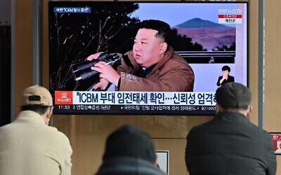People watch a television news screen showing a picture of North Korea's leader Kim Jong Un witnessing the recent test-firing of a Hwasong-17 intercontinental ballistic missile (ICBM), at a railway station in Seoul on March 17, 2023. (Jung Yeon-je/AFP)