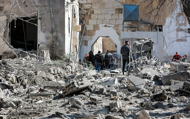 People inspect damage in the aftermath of an alleged Israeli air strike that hit the medieval Citadel of Damascus on February 19, 2023 (Louai Beshara/AFP) People inspect damage in the aftermath of an alleged Israeli air strike that hit the medieval Citadel of Damascus on February 19, 2023 (Louai Beshara/AFP)