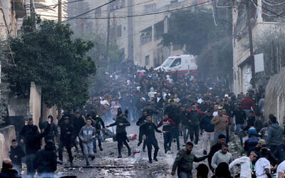Palestinians in Jenin refugee camp during an Israeli army raid, March 7, 2023. (Jaafar Ashtiyeh / AFP)