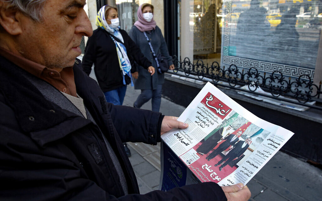 A man in Tehran holds a local newspaper reporting on its front page the China-brokered deal between Iran and Saudi Arabia to restore ties, signed in Beijing the previous day, on March, 11 2023. (ATTA KENARE / AFP) A man in Tehran holds a local newspaper reporting on its front page the China-brokered deal between Iran and Saudi Arabia to restore ties, signed in Beijing the previous day, on March, 11 2023. (ATTA KENARE / AFP)