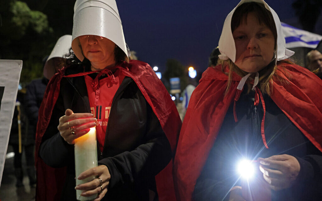 Protesters supporting women's rights dressed as characters from The Handmaid's Tale TV series attend a protest in Tel Aviv on March 18, 2023. (Jalaa Marey/AFP)