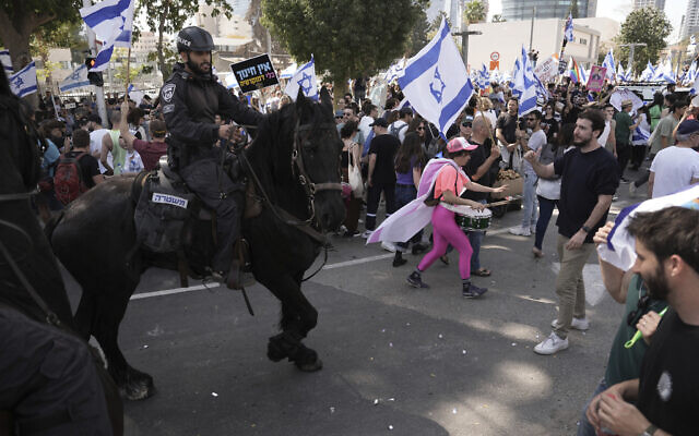 Mounted police push Israelis blocking a road during a protest against plans by Prime Minister Benjamin Netanyahu's government to overhaul the judicial system, in Tel Aviv, March 1, 2023. (AP Photo/Oded Balilty) Mounted police push Israelis blocking a road during a protest against plans by Prime Minister Benjamin Netanyahu's government to overhaul the judicial system, in Tel Aviv, March 1, 2023. (AP Photo/Oded Balilty)