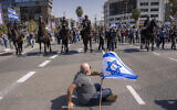 Mounted police are deployed as Israelis block a main road to protest against plans by Prime Minister Benjamin Netanyahu's new government to overhaul the judicial system, in Tel Aviv, Israel, March 1, 2023. (AP Photo/Oded Balilty)