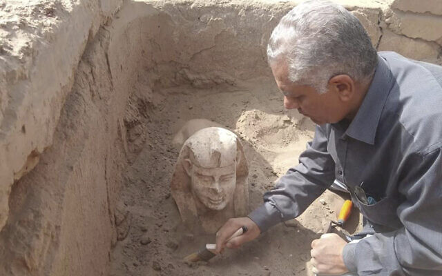 In this undated photo distributed March 6, 2023, by the Egyptian Ministry of Tourism and Antiquities, a sphinx statue believed to be made in the likeness of a Roman emperor is uncovered from an archaeological site in Qena, Egypt. (Egyptian Ministry of Tourism and Antiquities via AP)