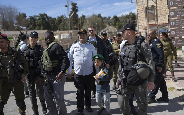 National Security Minister Itamar Ben Gvir, center, dressed in a costume combining elements of various uniforms of forces under his command, celebrates the Jewish holiday of Purim, in the West Bank city of Hebron, March 7, 2023. (AP/Ohad Zwigenberg) National Security Minister Itamar Ben Gvir, center, dressed in a costume combining elements of various uniforms of forces under his command, celebrates the Jewish holiday of Purim, in the West Bank city of Hebron, March 7, 2023. (AP/Ohad Zwigenberg)