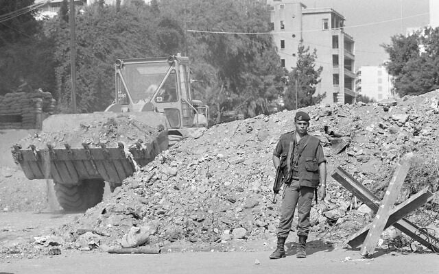 FILE - While a French trooper stands guard, an earth mover constructs a block of a street to beef up security near French paratroop command two days after it was attacked by a terrorist bomb, in Beirut, October 25, 1983. (AP Photo/Azakir, File) FILE - While a French trooper stands guard, an earth mover constructs a block of a street to beef up security near French paratroop command two days after it was attacked by a terrorist bomb, in Beirut, October 25, 1983. (AP Photo/Azakir, File)