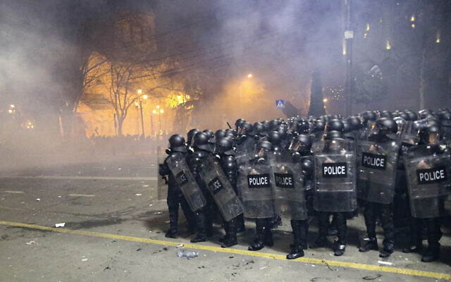 Riot police block a street to stop protesters outside the Georgian parliament building in Tbilisi, Georgia, March 8, 2023. (Zurab Tsertsvadze/AP)