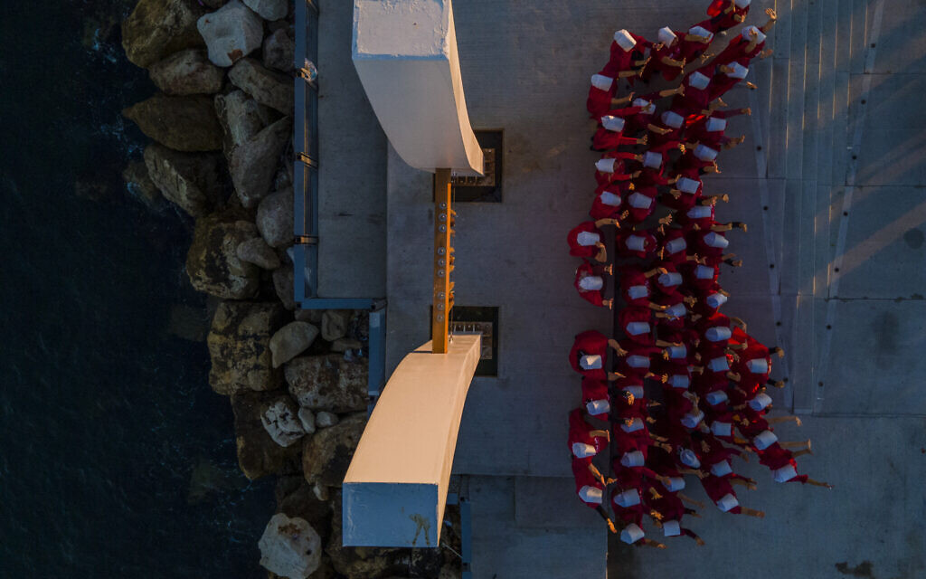 Protesters supporting women's rights dressed as characters from "The Handmaid's Tale" TV series attend a protest against the government's plans to overhaul the judicial system in the old port of Acre, northern Israel, March 16, 2023. (AP/Ariel Schalit)