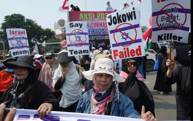 Protesters march during a protest in Jakarta, Indonesia, March 20, 2023. Dozens of conservative Muslims have marched in Indonesia's capital to protest against the Israeli team's participation in the FIFA World Cup Under-20 in Indonesia. (AP Photo/Achmad Ibrahim) Protesters march during a protest in Jakarta, Indonesia, March 20, 2023. Dozens of conservative Muslims have marched in Indonesia's capital to protest against the Israeli team's participation in the FIFA World Cup Under-20 in Indonesia. (AP Photo/Achmad Ibrahim)