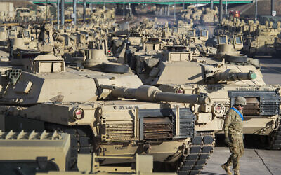 A soldier walks past a line of M1 Abrams tanks, November 29, 2016, at Fort Carson in Colorado Springs, Colorado.  (Christian Murdock/The Gazette via AP, File)