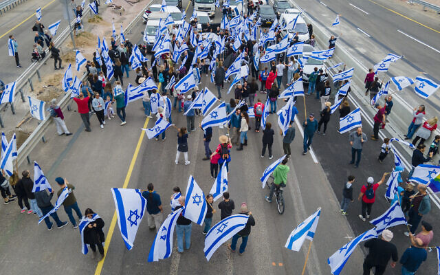 Israelis protest against the judicial overhaul by Prime Minister Benjamin Netanyahu's government at the Beit Yanai interchange, March 23, 2023. (AP Photo/Ariel Schalit) Israelis protest against the judicial overhaul by Prime Minister Benjamin Netanyahu's government at the Beit Yanai interchange, March 23, 2023. (AP Photo/Ariel Schalit)