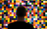A man looks to a painting '4900 Colours (excerpt)' in a new exhibition with art works of German artist Gerhard Richter at the New National Gallery in Berlin, Germany, Friday, March 31, 2023. (AP Photo/Markus Schreiber)