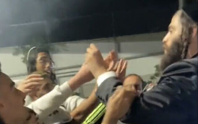 Screen capture from video of Elad mayor Yisrael Porush handing out cigarettes to children at a Purim event, March 7, 2023. (Twitter; used in accordance with Clause 27a of the Copyright Law) Screen capture from video of Elad mayor Yisrael Porush handing out cigarettes to children at a Purim event, March 7, 2023. (Twitter; used in accordance with Clause 27a of the Copyright Law)