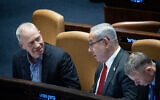 File: Defense Minister Yoav Gallant, left, speaks with Prime Minister Benjamin Netanyahu during a vote in the Knesset plenum in Jerusalem, February 15, 2023. (Yonatan Sindel/Flash90)