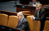 Prime Minister Benjamin Netanyahu (seated) with Justice Minister Yariv Levin in the Knesset in Jerusalem, on February 22, 2023. (Yonatan Sindel/Flash90)