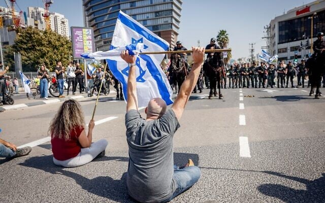Demonstrators block a road and clash with police as they protest against the government's planned judicial overhaul, in Tel Aviv, March 1, 2023. (Erik Marmor/Flash90) Demonstrators block a road and clash with police as they protest against the government's planned judicial overhaul, in Tel Aviv, March 1, 2023. (Erik Marmor/Flash90)