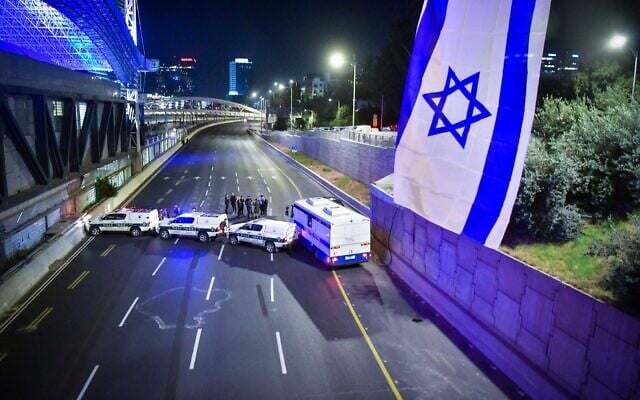 Police are seen on the Ayalon Highway during a demonstration against the government's planned judicial overhaul, in Tel Aviv, on March 11, 2023. (Erik Marmor/Flash90) Police are seen on the Ayalon Highway during a demonstration against the government's planned judicial overhaul, in Tel Aviv, on March 11, 2023. (Erik Marmor/Flash90)