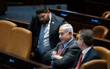 Prime Minister Benjamin Netanyahu (C) with Foreign Minister Eli Cohen (R) and MK Almog Cohen in the Knesset on March 13, 2023. (Yonatan Sindel/Flash90)