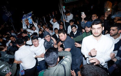 Police push back supporters of ultra-Orthodox MK Moshe Gafni during clashes with anti-overhaul activists, outside Gafni's home in Bnei Brak, on March 14, 2023. (Erik Marmor/Flash90)