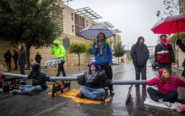 Protesters against the judicial overhaul block a road near the government complex in Jerusalem, March 14, 2023 (Yonatan Sindel/Flash90) Protesters against the judicial overhaul block a road near the government complex in Jerusalem, March 14, 2023 (Yonatan Sindel/Flash90)