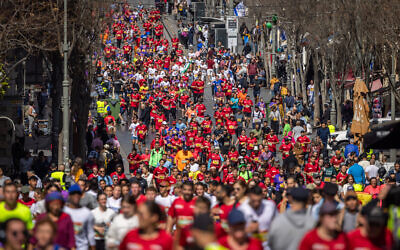 Thousands of runners take part in the 12th annual Jerusalem Marathon on Jaffa Street, March 17, 2023. (Yonatan Sindel/Flash90)