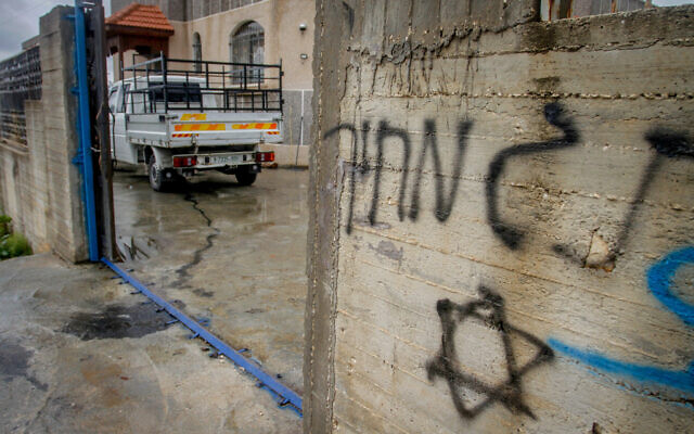 The scene where Palestinian-owned cars and the wall of a home was graffitied in a suspected settler hate crime in the West Bank city of Salfit, March 20, 2023. (Nasser Ishtayeh/Flash90) The scene where Palestinian-owned cars and the wall of a home was graffitied in a suspected settler hate crime in the West Bank city of Salfit, March 20, 2023. (Nasser Ishtayeh/Flash90)