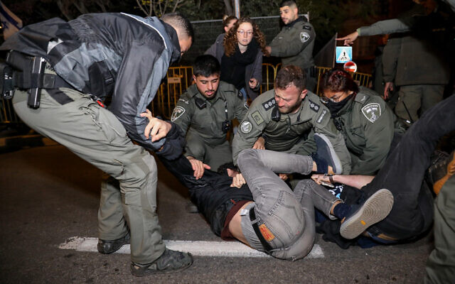 Police scuffle with a protester outside the home of Prime Minister Benjamin Netanyahu in Jerusalem, March 26, 2023. (Noam Revkin Fenton/Flash90) Police scuffle with a protester outside the home of Prime Minister Benjamin Netanyahu in Jerusalem, March 26, 2023. (Noam Revkin Fenton/Flash90)
