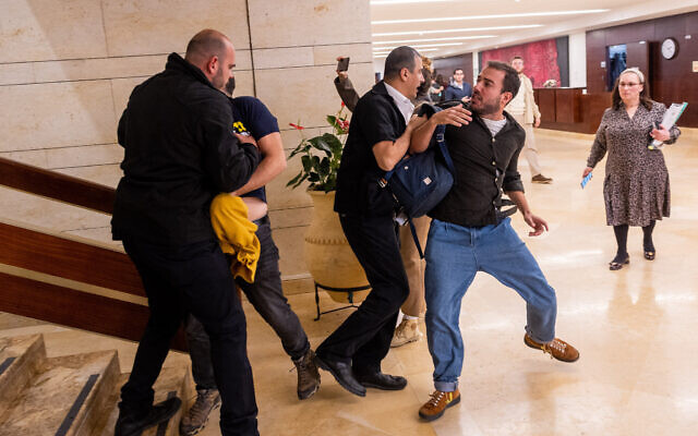 Demonstrators who oppose the government's planned judicial overhaul shout at Education Minister Yoav Kisch at the Knesset in Jerusalem, March 27, 2023. (Yonatan Sindel/Flash90) Demonstrators who oppose the government's planned judicial overhaul shout at Education Minister Yoav Kisch at the Knesset in Jerusalem, March 27, 2023. (Yonatan Sindel/Flash90)