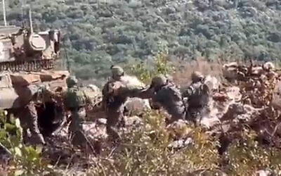 Israeli troops are seen carrying a wounded soldier on the border with Lebanon after an old mine exploded, March 21, 2023. (Screenshot: Twitter)