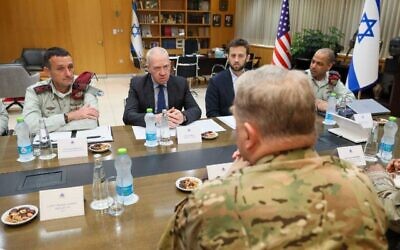 This handout photo from March 3, 2023, shows IDF Chief of Staff Herzi Halevi (left), Defense Minister Yoav Gallant (second left) and other officials holding talks with visiting Gen. Mark Milley, the chairman of the US Joint Chiefs of Staff (back to camera) and his colleagues. (Sivan Shachor/GPO)